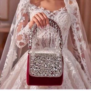 Luxury crystal velvet bridal bag for wedding day held by bride in white gown